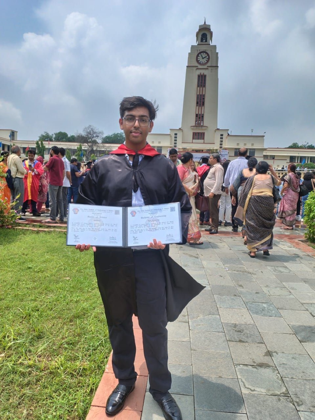 Harshit at his BITS Pilani graduation with the clock tower behind him