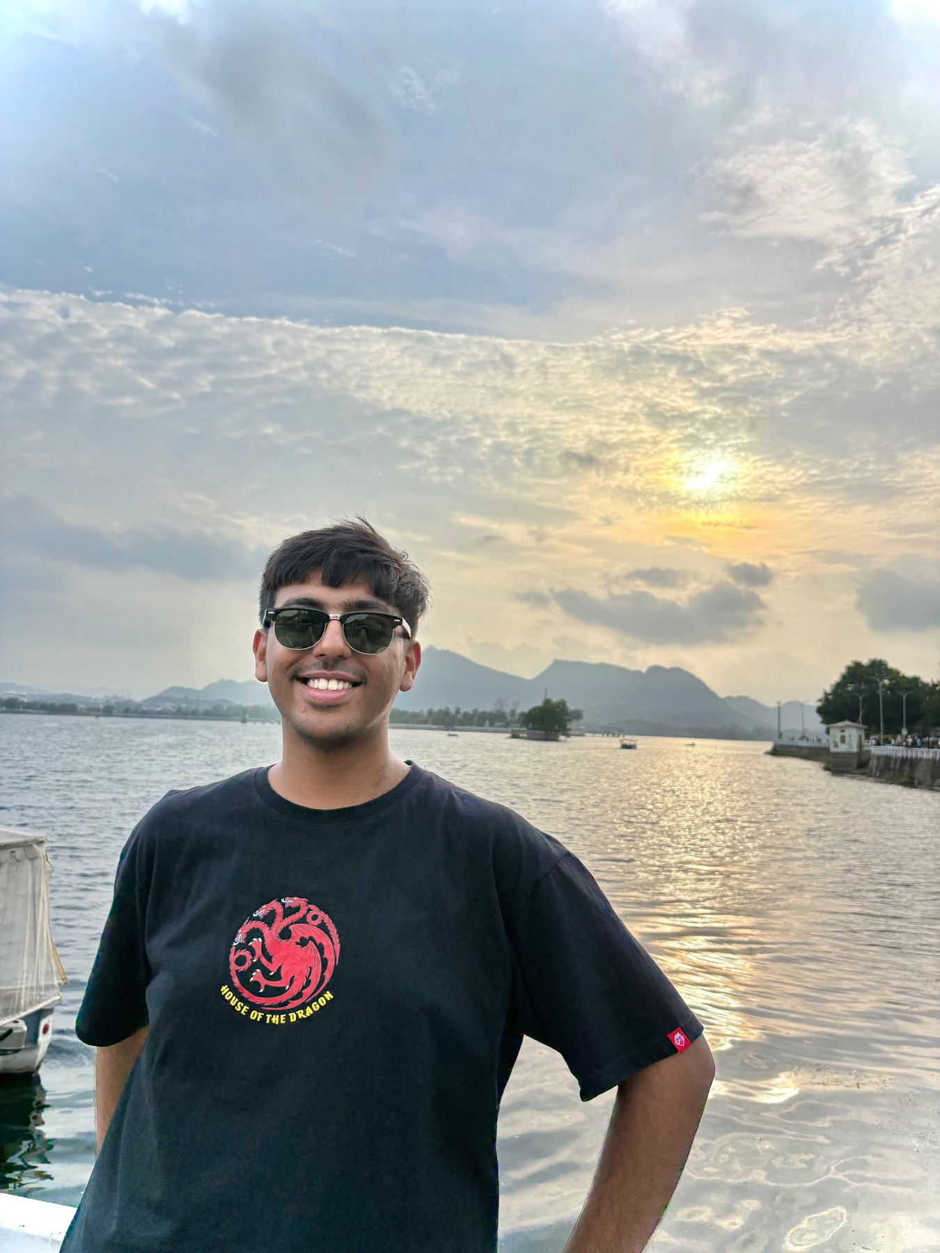Harshit by a lake at sunset